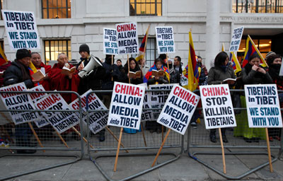 Tibetan monks lead a prayer vigil outside the Chinese Embassy in London Wednesday. (AFP/Justin Tallis)