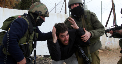 The camera of AFP photographer Musa al-Sha'er was broken by Israeli soldiers shortly after he took this photograph of a protester being detained at a demonstration in the West Bank. (AFP/Musa al-Sha'er)