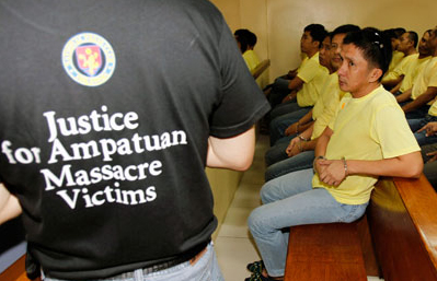 An advocate for the Maguindanao massacre victims appears at a court hearing near several police officers charged in the killings. (Reuters/Romeo Ranoco)
