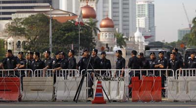 Police officers stand guard during Saturday's protest. (Reuters/Bazuki Muhammad)