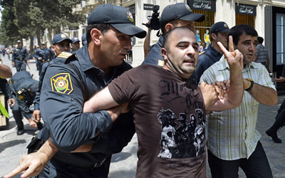 Police in Baku arrest a man during a protest seeking reforms in conjunction with Eurovision. (DAPD/Joern Haufe)