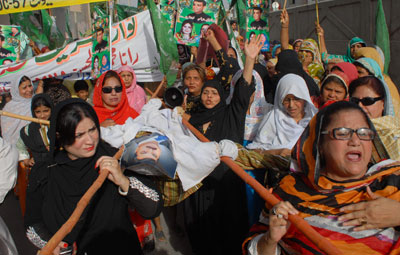 Supporters of a Pakistani opposition party carry effigies of Prime Minister Yousuf Raza Gilani and President Asif Ali Zardari at a protest rally in Multan on May 11. (AFP/S.S. Mirza