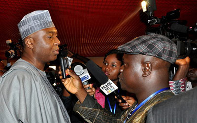 Police shielded parliamentarian and former state governor Bukola Saraki, left, from journalists after he was questioned by a police fraud unit. (247nigerianewsupdate.com)