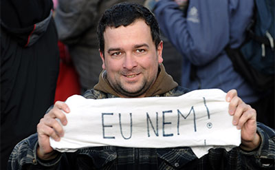 A Hungarian holds a banner reading 'EU No!' in Budapest on March 15, 2012, during a commemoration of the 1848-1849 Hungarian revolution and independence war. (AFP/Attila Kisbenedek)