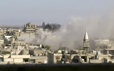 An image released by the Shaam News Network shows heavy shelling in Homs. At least five journalists were killed in Syria at the end of May, two of them in Homs. (AP/Shaam News Network)