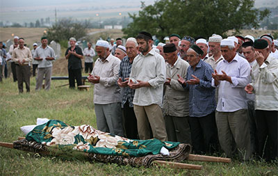 People pray at the burial of Natalya Estemirova in Chechnya July 16, 2009. (AP/Musa Sadulayev)