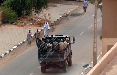 Sudanese security forces pass through a Khartoum street on Monday. (AFP/Ian Timberlake)