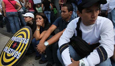 RCTV employees in 2010 after the station was pulled off cable television. The sign says, 'Journalists targets.' (AP/Fernando Llano)