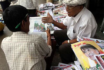 Two men chat at a roadside weekly journal shop in Rangoon on Monday. Burma's government said it would abolish the practice of censoring publications before they are printed. (AP/Khin Maung Win)