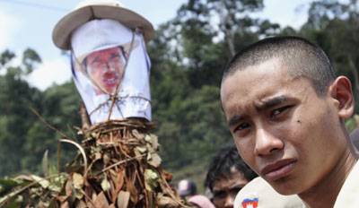 Chut Wutty's son stands near a picture of his father during a commemoration ceremony. (Reuters/Samrang Pring)
