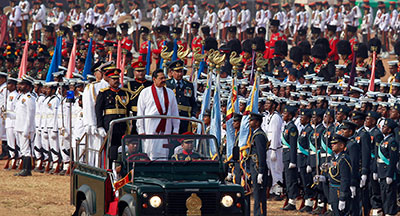 Sri Lankan President Mahinda Rajapaksa, in white, inspects a parade May 19 marking the third anniversary of the defeat of Tamil Tiger separatists. (Reuters/Dinuka Liyanawatte)