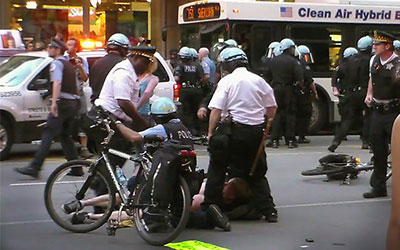 A demonstrator is arrested in downtown Chicago during a protest against the NATO Summit in May 2012. (Mickey H. Osterreicher)