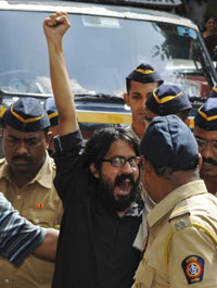 Aseem Trivedi shouts slogans as he is escorted by police outside court. (Reuters)