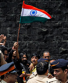 Indian political cartoonist Aseem Trivedi waves the national flag after being released from jail on bail in Mumbai on September 12. (AP/Rajanish Kakade)