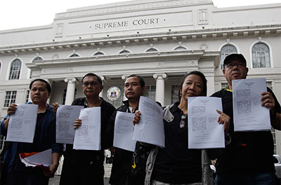 Filipino journalists show petitions against the Cybercrime Prevention Act that they submitted to the Supreme Court in Manila on Wednesday. (AP/Aaron Favila)