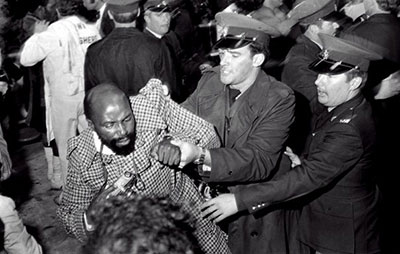 Alf Kumalo being arrested at a boxing match in Johannesburg in May 1976. (Alf Kumalo Foundation and Photographic Museum)