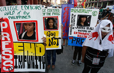 Journalists march in Manila to mark the second anniversary of the massacre of at least 57 people, including 32 journalists, in Maguindanao on November 23, 2011. The International Day to End Impunity commemorates the massacre. (AP Photo/Bullit Marquez)