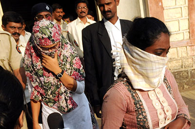Shaheen Dhada, left, and Renu Srinivas, Indian women arrested for their Facebook posts, leave a Mumbai court Tuesday. (AP)