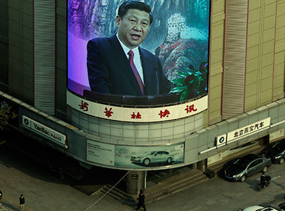 A mall's screen shows new Chinese Communist Party leader Xi Jinping in Beijing Thursday. (AP Photo/Lee Jin-man)