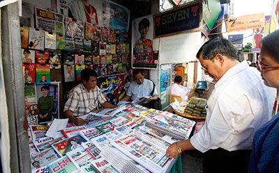Customers buy weekly news journals at a roadside shop in Yangon, Myanmar, Friday. Authorities said they will allow private daily newspapers starting in April for the first time since 1964. (AP/Khin Maung Win)