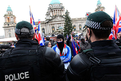Protesters block the road in front of Belfast City Hall to protest a decision to limit display of the union flag. (Reuters/Cathal McNaughton)