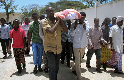 Friends and relatives carry the body of Abdisatar Daher Sabriye, a  journalist with state-run television who died in a September 20 suicide bomb attack. (AP/Mohamed Sheikh Nor)