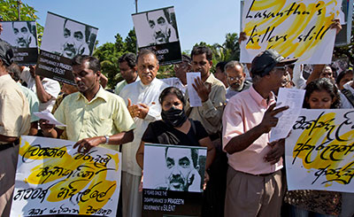 Journalists, rights activists, and opposition lawmakers, with Sandya Eknelygoda in the center, protest attacks on journalists and authorities' failure to punish the culprits in Colombo Tuesday. (AP/Gemunu Amarasinghe)