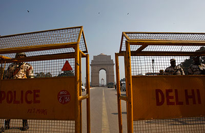 Indian policemen stand guard near India Gate in New Delhi. A magistrate ruled Monday that the media will not be allowed to attend the trial of five men accused of raping and killing a young student. (AP/Tsering Topgyal)