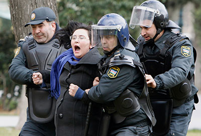 Police in Baku detain a woman who was protesting in solidarity with Ismayilli residents after a riot on January 26. (Reuters/David Mdzinarishvili)