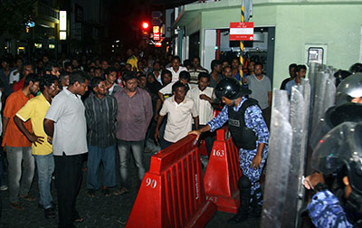 Supporters of former President Nasheed gather outside the Indian High Commission where Nasheed sought refuge to evade arrest. (AP/Ahmed Mujthaba)