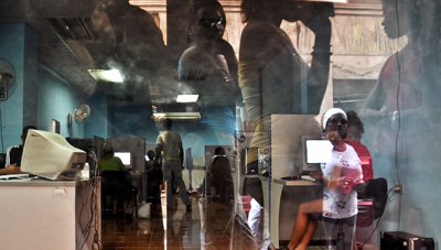 Cuban citizens waiting to use the Web stand outside an Internet café in Havana. (AFP)