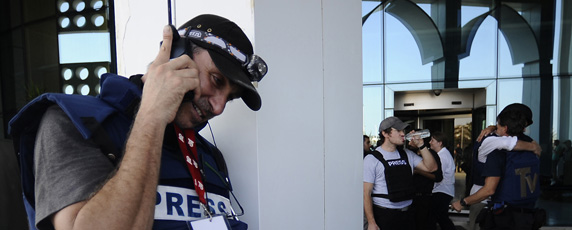 A journalist in Libya speaks on his satellite phone. (AFP/Filippo Monteforte)