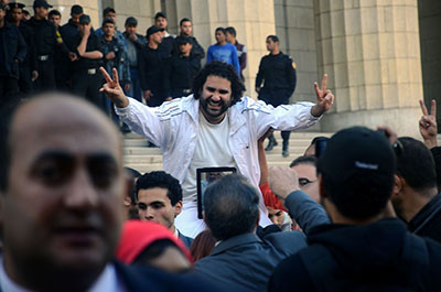 Egyptian blogger Alaa Abdel Fattah is surrounded by supporters as he leaves the prosecutor general's office in Cairo on Tuesday. (AP/Mostafa Darwish)