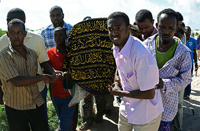 Mourners carry the coffin of Somali journalist Mohamed Ibrahim Raage in Jazira on the outskirts of Mogadishu on Monday. (AFP/Mohamed Abdiwahab)