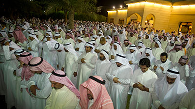 Supporters of Kuwaiti opposition politician Musallam al-Barrak pray in the yard of his house in Andulos, after he was sentenced to jail for insulting the emir, April 15. (Reuters/Stephanie McGehee)