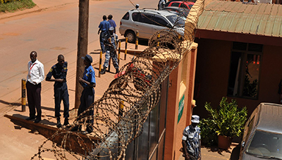 Police stand outside the offices of the Daily Monitor. (Daily Monitor)