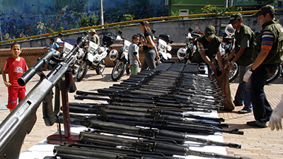 Colombian police display weapons confiscated during a raid on a criminal gang in the town of Tarazá. (Reuters/Fredy Amariles)