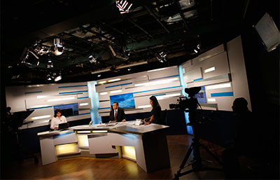 Leopoldo Castillo, center, pauses during his daily broadcast  of 'Alo Ciudadano' Tuesday on Globovisión. (Reuters/Jorge Silva)