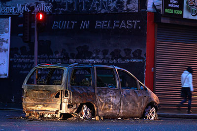 A burnt out car blocks Dee Street in east Belfast in January. Threats against journalists have increased since a wave of protests early this year. (Reuters/Cathal McNaughton)