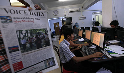 A journalist holds a copy of The Voice at a newsroom in Rangoon. (Reuters/Soe Zeya Tun)