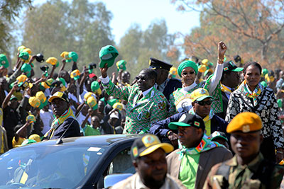 Zimbabwean President Robert Mugabe and his wife Grace greet party supporters on their arrival at a campaign rally in Chitungiwiza, Zimbabwe, on Tuesday. (AP/Tsvangirayi Mukwazhi)