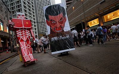 A defaced picture of Hong Kong Chief Executive Leung Chun-ying is displayed during an annual pro-democracy protests in Hong Kong on July 1.(AP/Vincent Yu)