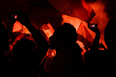 Opponents of Mohammed Morsi wave national flags at a protest outside the presidential palace in Cairo on Monday. (AP/Nariman El-Mofty)