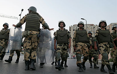 Military special forces march to surround supporters of Mohammed Morsi in Nasr City, Cairo, on Wednesday. (AP/Hassan Ammar)
