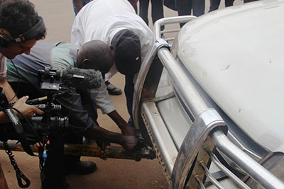 Moments before his arrest, Taylor Krauss films damage to opposition leader Kizza Besigye's car by police. (Chimpreports)