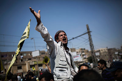 A supporter of Egypt's ousted President Mohamed Morsi chants slogans against the military Friday in Cairo. (AP/Manu Brabo)
