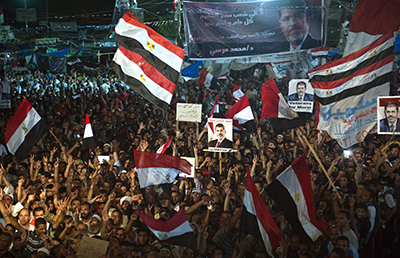 Members of the Muslim Brotherhood and supporters of ousted President Mohammed Morsi participate in a sit-in outside the Rabaa al-Adawiya mosque. (AFP/Khaled Desouki)