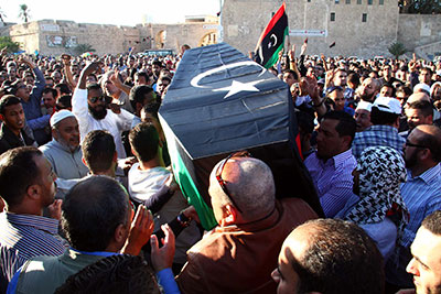 Mourners carry the coffin of one of the victims of a shootout the previous day at an anti-militia protest in Tripoli, on November 16, 2013. (AFP)