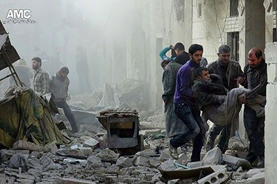 This image provided by Aleppo Media Center shows Syrians helping a wounded man from the scene of a government airstrike in Aleppo on December 17. Citizen journalists have been central to documenting the conflict's death and destruction. (AP/Aleppo Media Center)