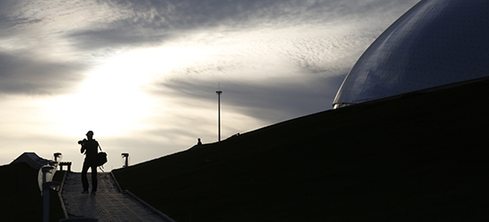 A photographer walks outside a dome built for the Sochi Games. (Reuters/Pawel Kopczynski)